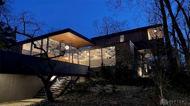 view of side of home with stairs