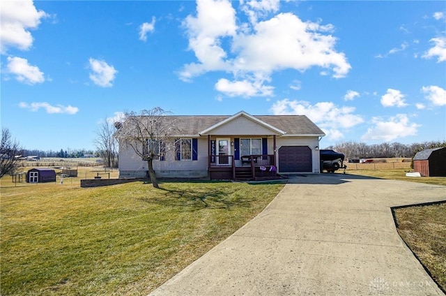 single story home featuring driveway, a storage shed, a garage, a porch, and a front yard