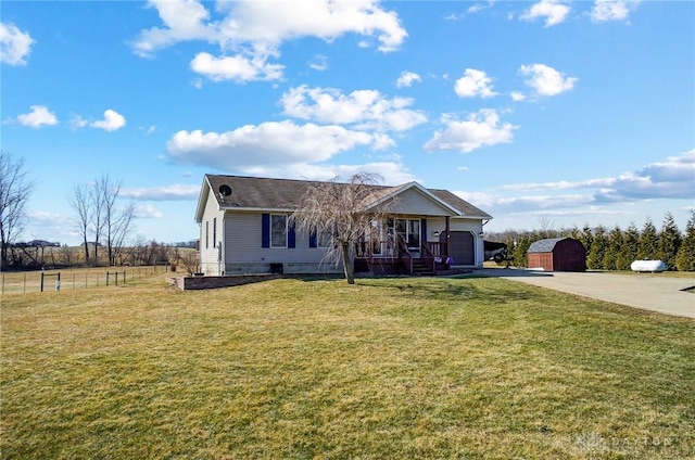 ranch-style house featuring driveway, covered porch, fence, and a front lawn