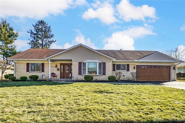 single story home featuring driveway, brick siding, an attached garage, and a front yard