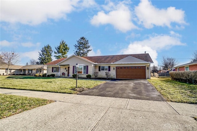 ranch-style house with a front lawn, an attached garage, brick siding, and aphalt driveway