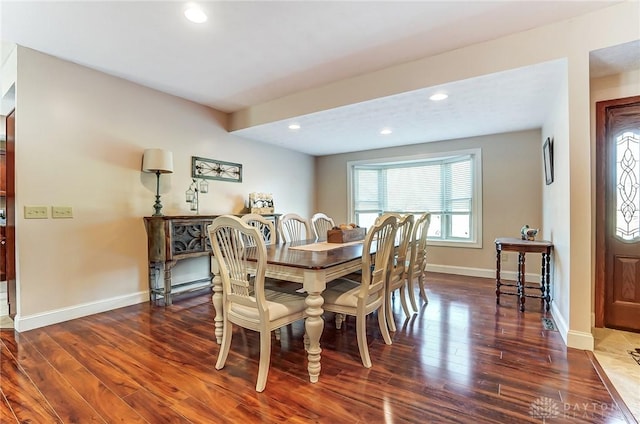 dining room with dark wood-style flooring, recessed lighting, and baseboards