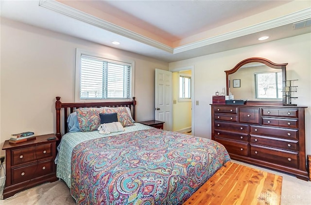 bedroom featuring light carpet, a tray ceiling, visible vents, and recessed lighting