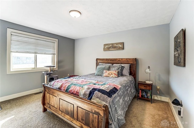 carpeted bedroom with visible vents and baseboards