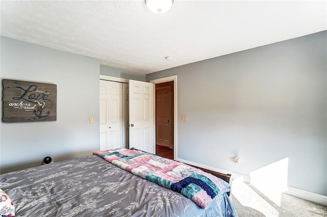 bedroom featuring baseboards and a closet