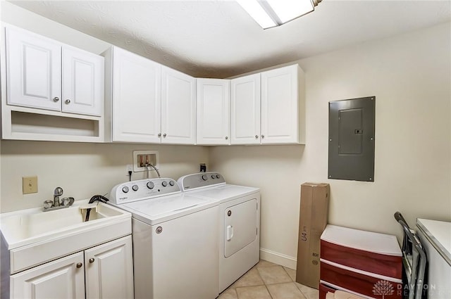 clothes washing area featuring light tile patterned flooring, a sink, independent washer and dryer, cabinet space, and electric panel