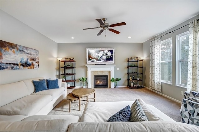 living room featuring light carpet, recessed lighting, baseboards, and a tile fireplace