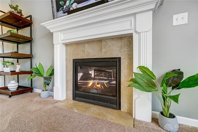 interior details featuring carpet flooring, a fireplace, and baseboards