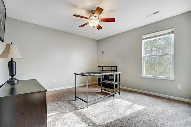 carpeted office featuring baseboards, visible vents, and ceiling fan