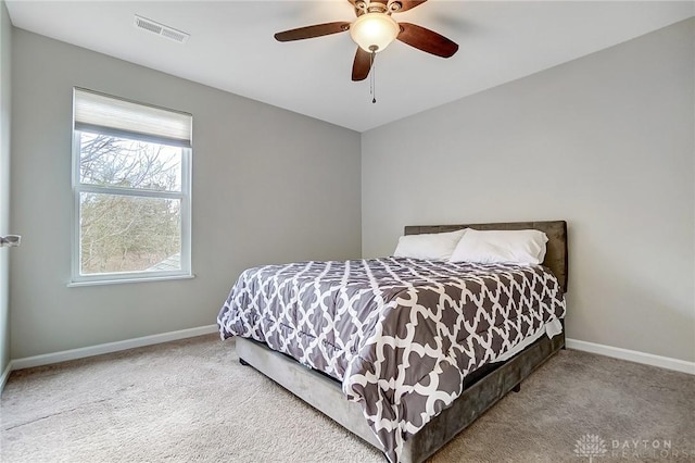 bedroom with light carpet, baseboards, visible vents, and ceiling fan