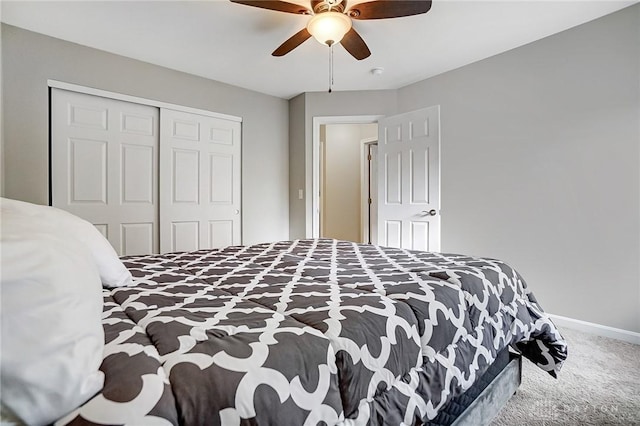 carpeted bedroom featuring a closet, ceiling fan, and baseboards