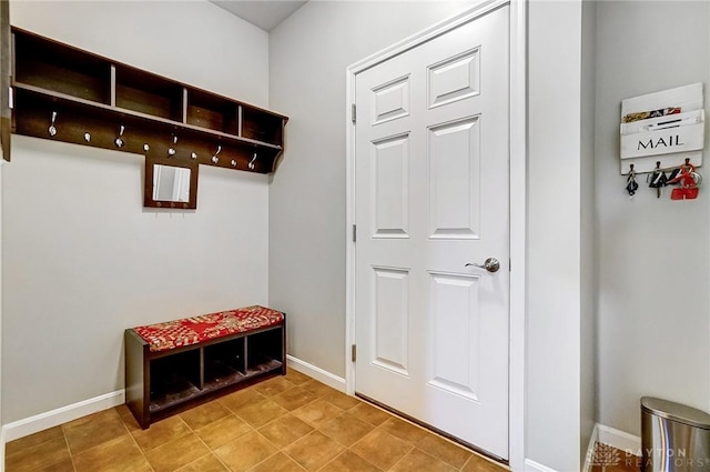 mudroom with light tile patterned floors and baseboards