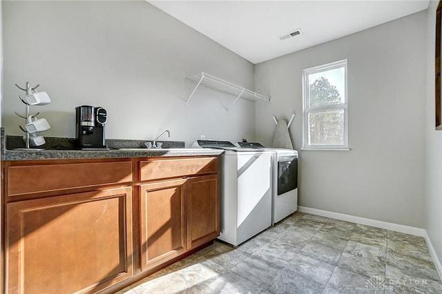 laundry area with cabinet space, baseboards, visible vents, and washer and clothes dryer