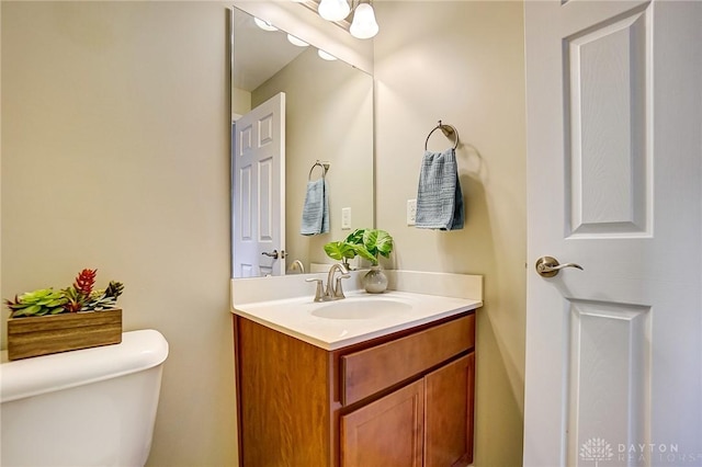 bathroom with toilet and vanity