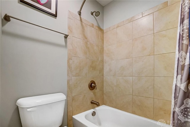 bathroom featuring shower / bath combination with curtain and toilet