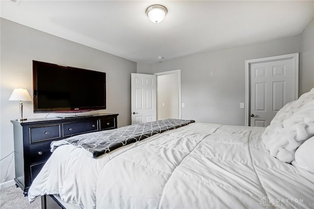 bedroom with carpet floors and baseboards