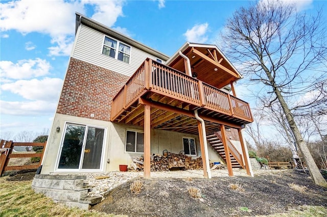 rear view of house featuring a deck and stairway