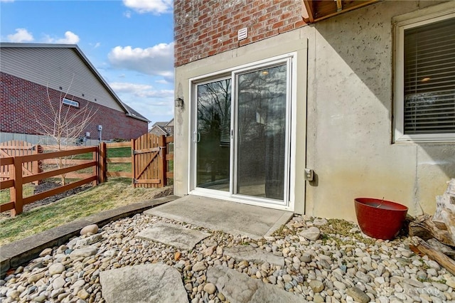 view of patio / terrace featuring fence and a gate