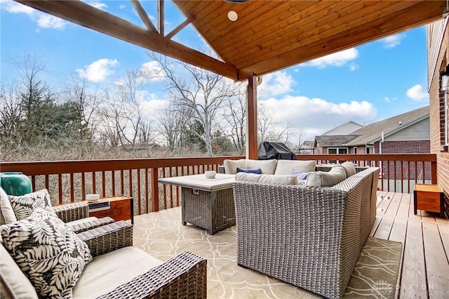 wooden deck with an outdoor living space