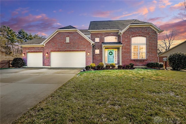 view of front of property with an attached garage, a lawn, brick siding, and driveway