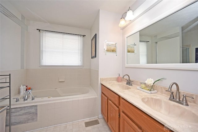 bathroom with double vanity, a garden tub, and a sink