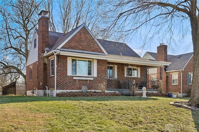 view of front facade featuring a front yard, brick siding, and a chimney