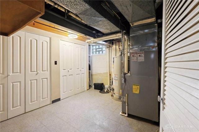 basement featuring heating unit, water heater, and tile patterned floors