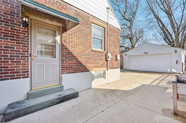 doorway to property with a garage and brick siding