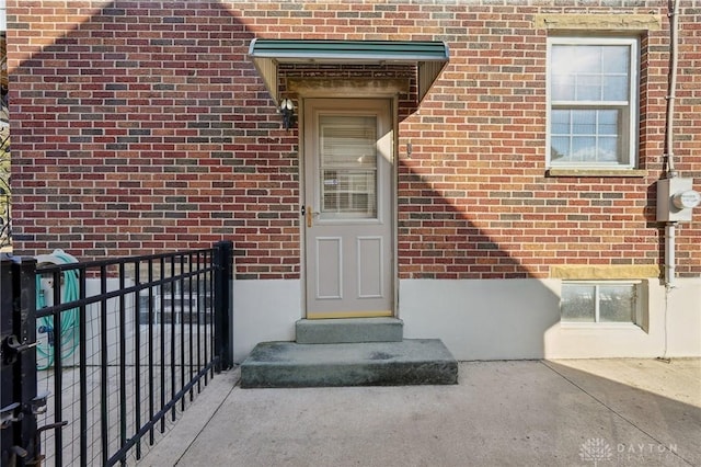 view of exterior entry with brick siding