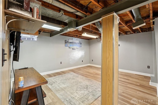 basement with wood finished floors and baseboards