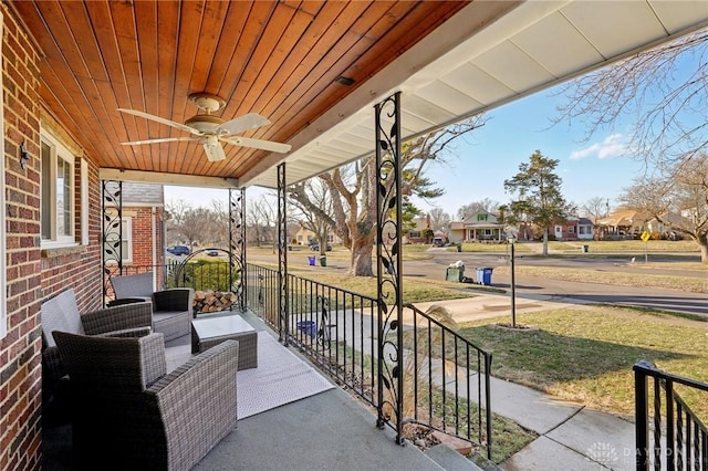 view of patio featuring a residential view, covered porch, and ceiling fan