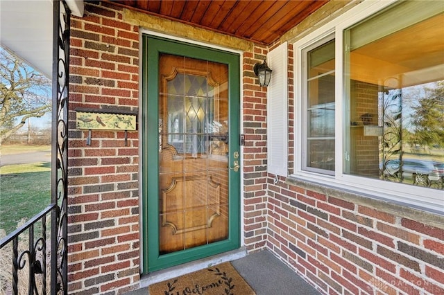 view of exterior entry with brick siding