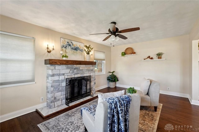 living room with a fireplace, dark wood finished floors, and baseboards