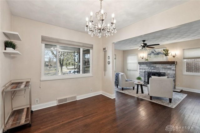 living area with ceiling fan, dark wood-style flooring, a fireplace, visible vents, and baseboards