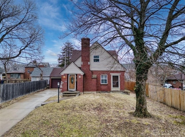 bungalow-style house with a garage, brick siding, fence, concrete driveway, and a chimney