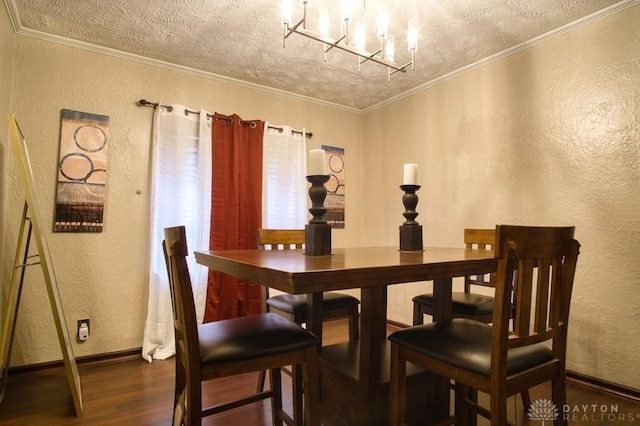 dining room featuring crown molding, a textured wall, a textured ceiling, wood finished floors, and baseboards