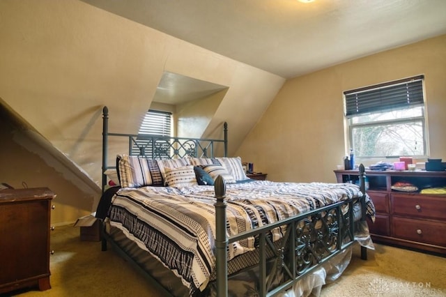 carpeted bedroom featuring lofted ceiling