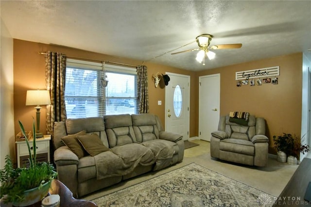 living area featuring light colored carpet and ceiling fan