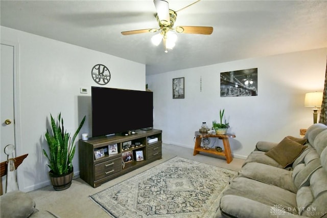 living room featuring carpet floors, a ceiling fan, and baseboards