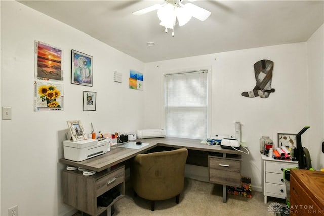 office space featuring light carpet and ceiling fan