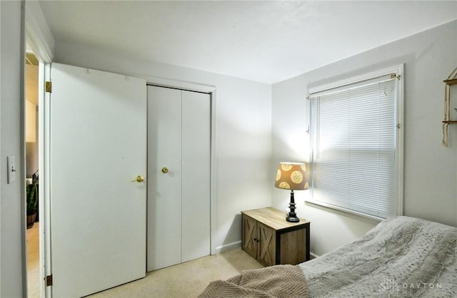 bedroom featuring a closet and light carpet