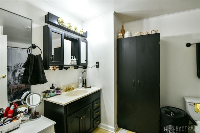 bathroom featuring crown molding and vanity