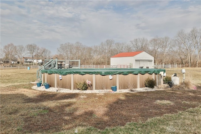 view of swimming pool with a covered pool and a yard