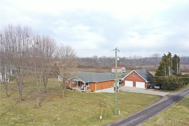 view of front of property featuring a garage, a porch, a front yard, and concrete driveway