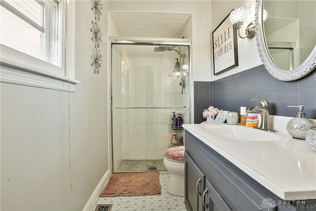 bathroom with vanity, tile patterned flooring, a shower stall, and toilet