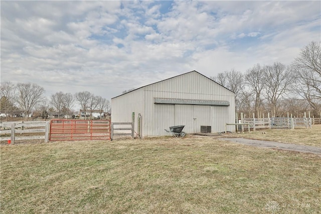 view of pole building with fence, a yard, and cooling unit