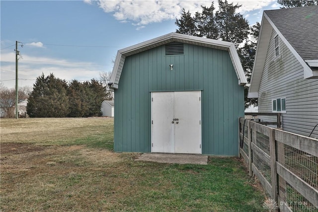view of shed featuring fence