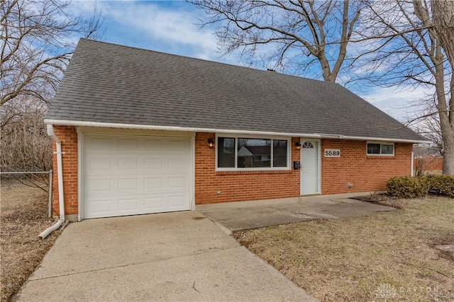 view of front facade featuring a shingled roof, concrete driveway, and brick siding