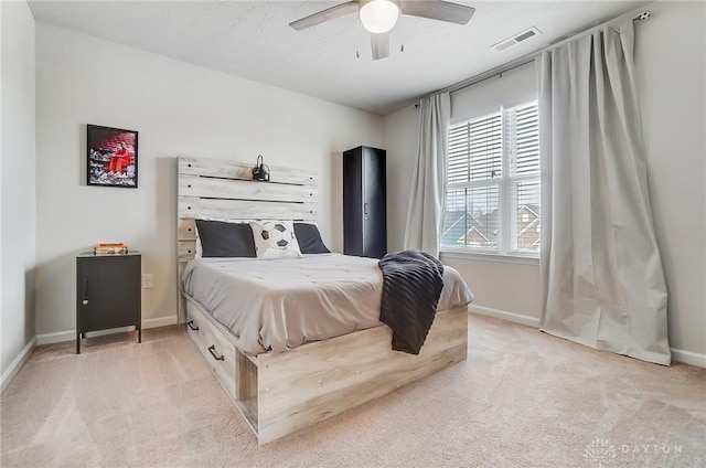 bedroom featuring baseboards, a ceiling fan, visible vents, and light colored carpet