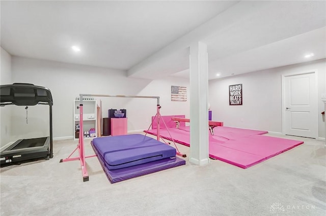 exercise area with baseboards, recessed lighting, and light colored carpet